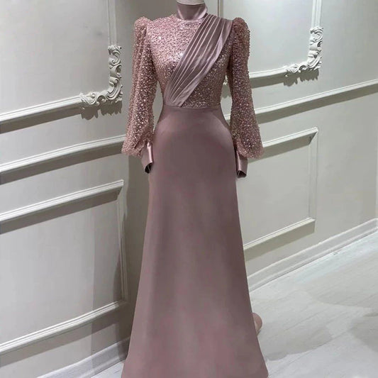Elegant satin long-sleeve dress with zipper and beaded accents. Available in slim and plus sizes. Long skirt, polyester fabric. Sizes US2–US16+.