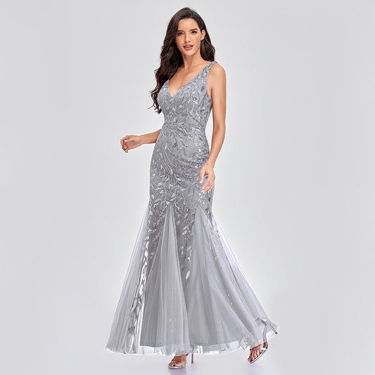 Luxurious sleeveless wedding dress with embroidered bead details, elegant V-neckline, and fishtail silhouette. Features a trailing hem and mid-waist fit for a romantic bridal look.