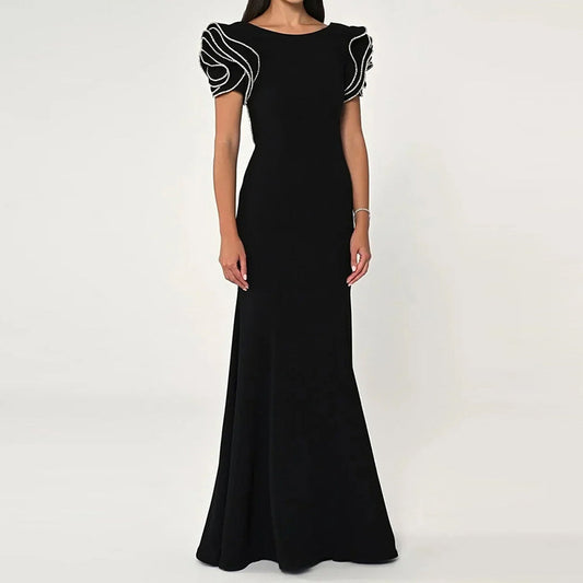 Elegant black fishtail dress with folding details and stitched polyester design. Perfect for casual or semi-formal occasions.