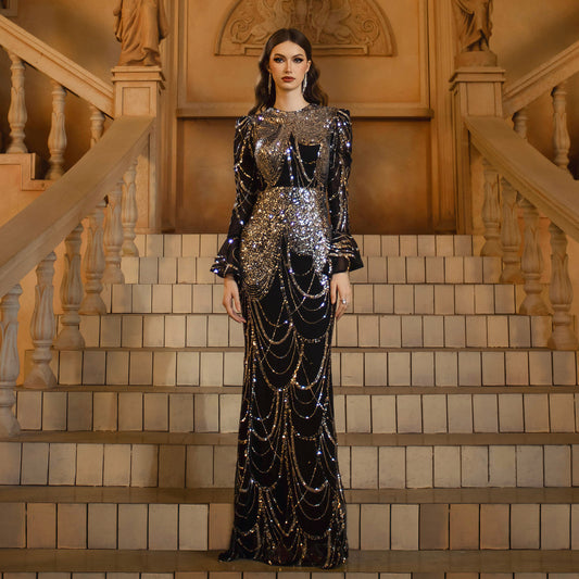 Elegant black and silver long dress featuring dazzling sequins, a flattering high waist, and a sleek hip skirt silhouette. Crafted from soft polyester with long sleeves – perfect for formal events, parties, and special occasions.