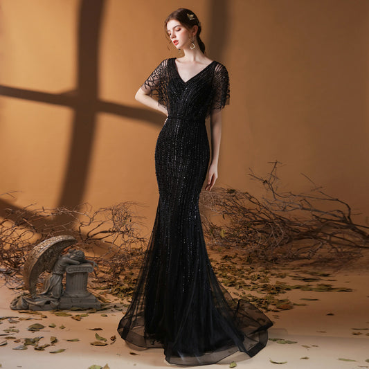 Turn heads with our fashion-forward fishtail dress featuring elegant flying sleeves and a flattering mid-waist fit. Available in solid black, wine red, gold, and gray – perfect for parties or special occasions.