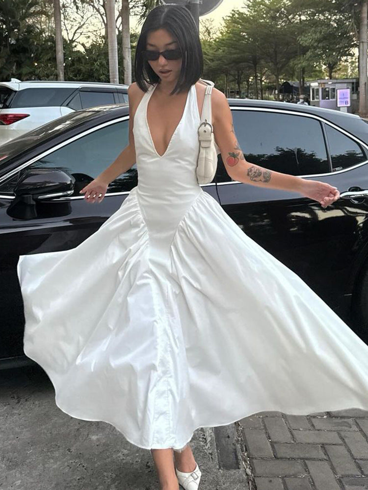Turn heads in this deep V-neck halter dress with hollow-out accents and a flared hem. Elegant, sexy, and perfect for parties, dates, or summer nights.Women
