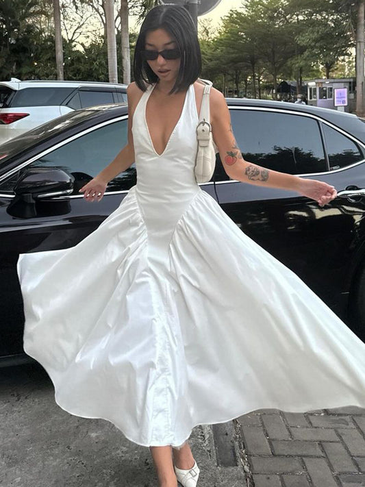 Turn heads in this deep V-neck halter dress with hollow-out accents and a flared hem. Elegant, sexy, and perfect for parties, dates, or summer nights.Women